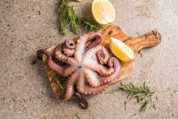 Octopus cooked with chopped herbs served on a board