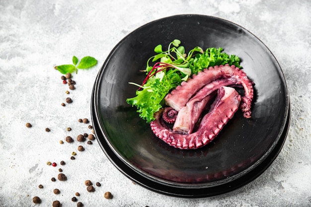 Octopus food in a plate seafood second course fresh ready to eat meal snack on the table copy space