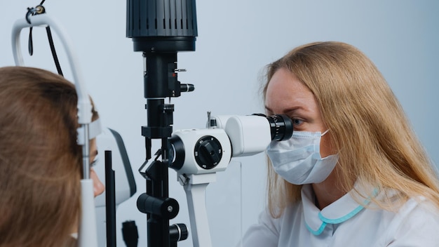 The oculist doctor during the patient's appointment The doctor uses a modern slit lamp