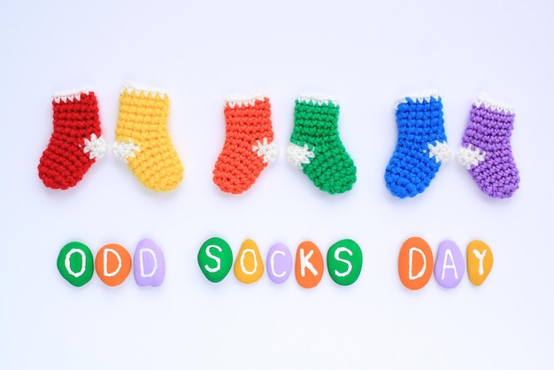 Odd socks day lettering and mismatched colourful socks on white background. Social school bullying c