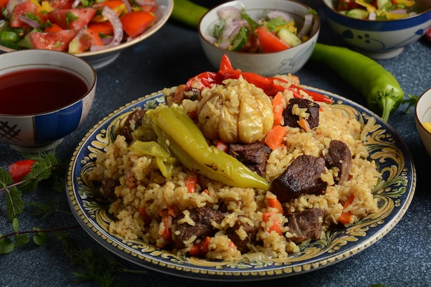 Oezbeekse keuken (voedsel) pilaf (plov), salade achichuk (achuchuk). Schapen, rijst, wortelen, plantaardige olie, rozijnen, ui, kurkuma, zwarte peper, komijn