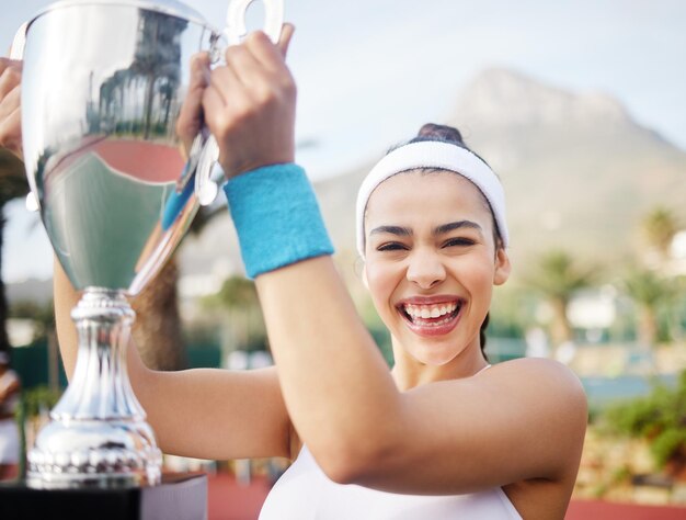 On and off the court Im winning Shot of an attractive young tennis player holding up a trophy