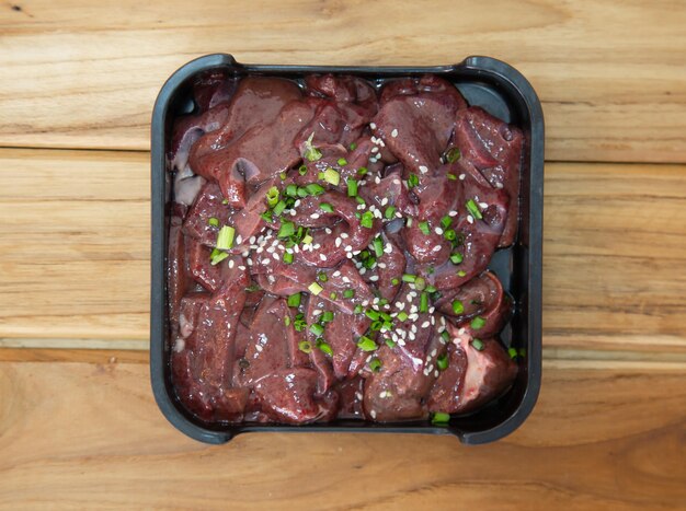 Offal on square plate isolated on wooden background shabu hot pot ingredients