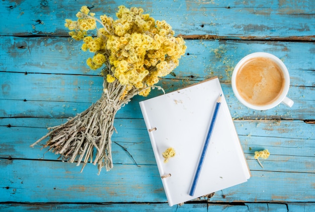 Ð¡offee mug with a bouquet of dried wildflowers