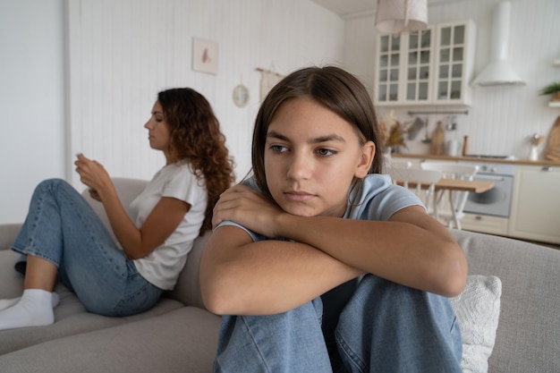 Offended teen girl feeling sad after fight with mother thinking of conflict argument with mom