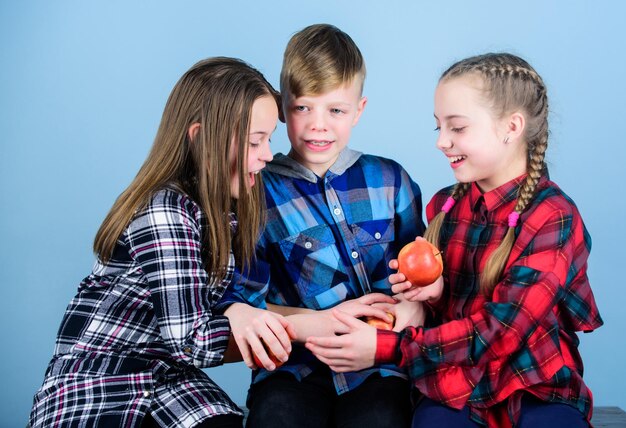 Offering healthy foods for kids little children holding red apples cute children with healthy apple snack small group of children enjoy healthy eating together healthy children