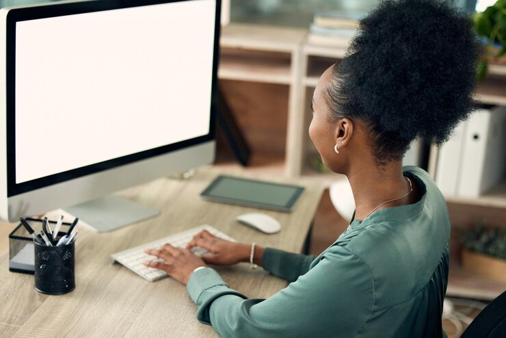 Photo office black woman and typing on computer with screen for online research and information as hr manager back view female employee and mockup in pc for administration work deadline and task