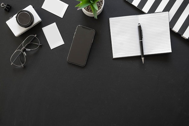 Photo office black workspace with office supplies and copy space on black background, flat lay