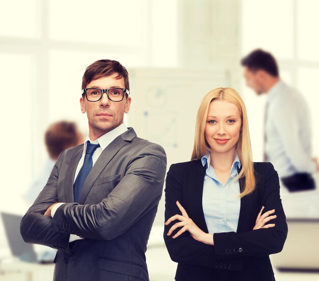 office, buisness, teamwork concept - businessman and businesswoman in the front of team