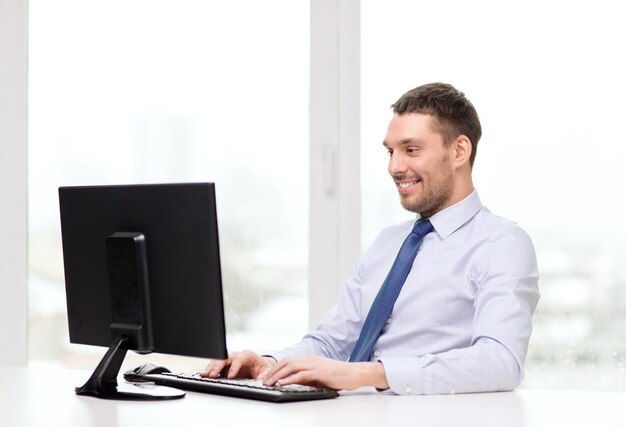 office, business, education, technology and internet concept - smiling businessman or student with computer