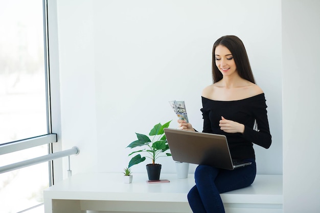 Office Business Woman Smiling and Sitting on the Table