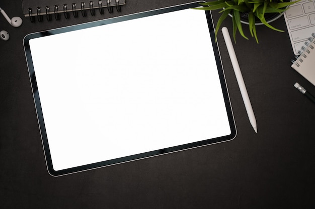 Office dark leather desk with blank screen mockup tablet