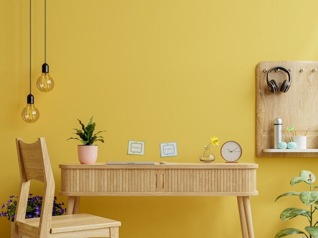 Office desk interior with mockup yellow wall.3d rendering