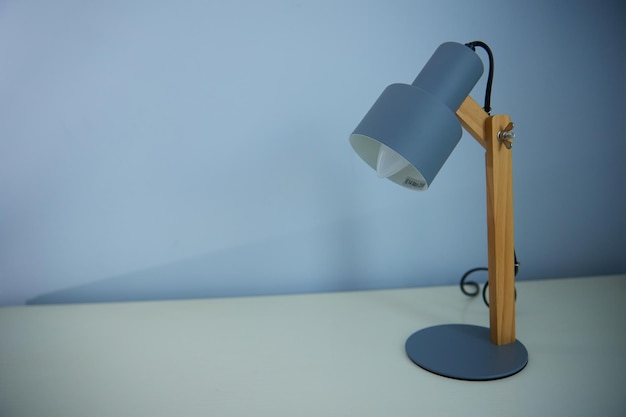 An office desk lamp illuminating the background lots of copy\
space