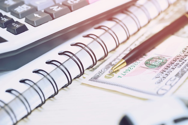 Office desk table calculator with notepad book, bank account and black pen. Top view with copy space. investment calculation Accounting, financial concept