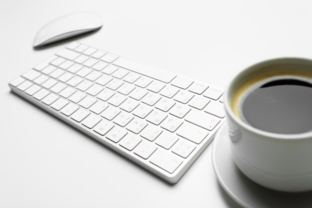 Office desk table with computer, supplies and coffee cup