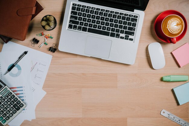 Office desk table with keyboardcalculatorpencilmousefinancial data or chat or graph