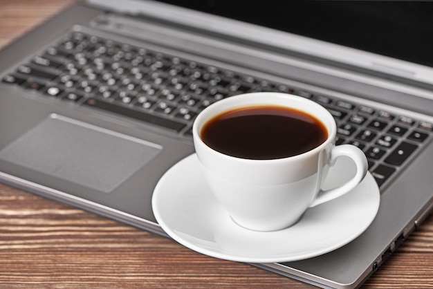 Office desk table with laptop and coffee cup