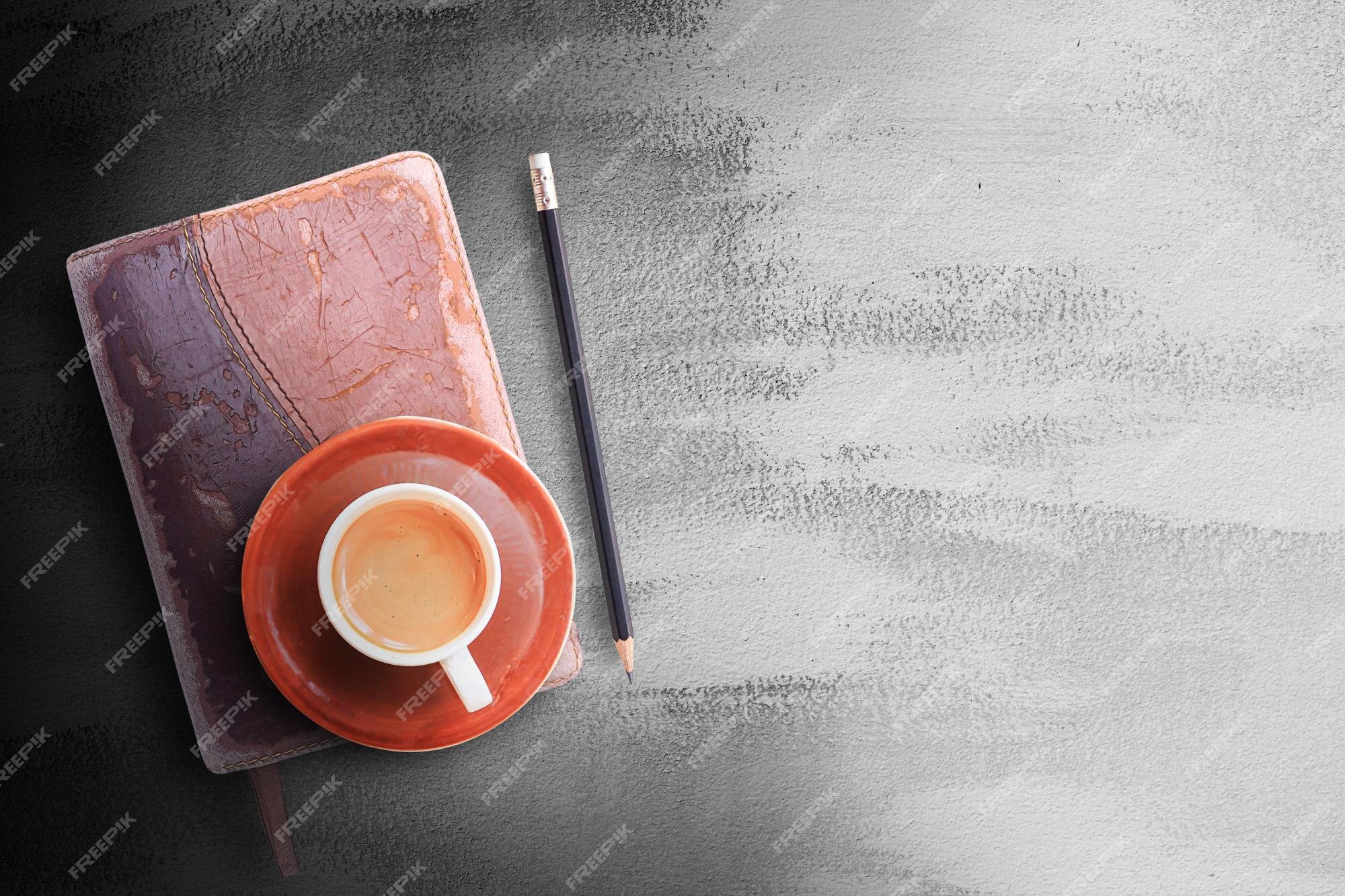 Premium Photo  Office desk table with notebookpencil and coffee cup