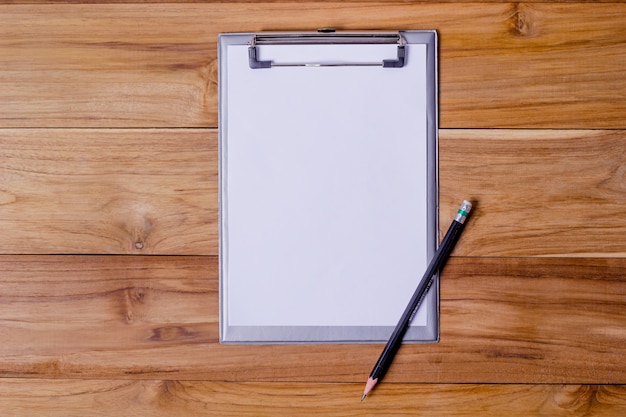 Office desk table with short notepaper and pencil.