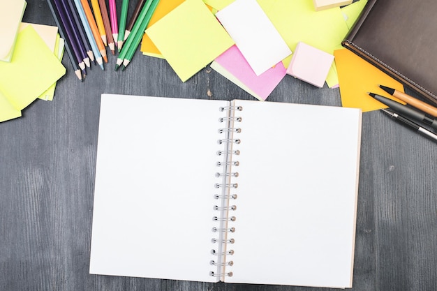 Office desk top with empty notebook