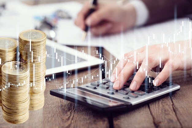 Photo the office desk with a calculator, cash coins and papers