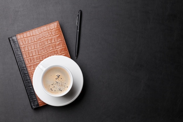 Office desk with coffee notepad and pen