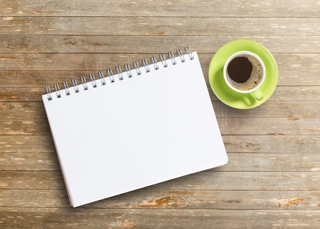 Office desk with notebook and coffee