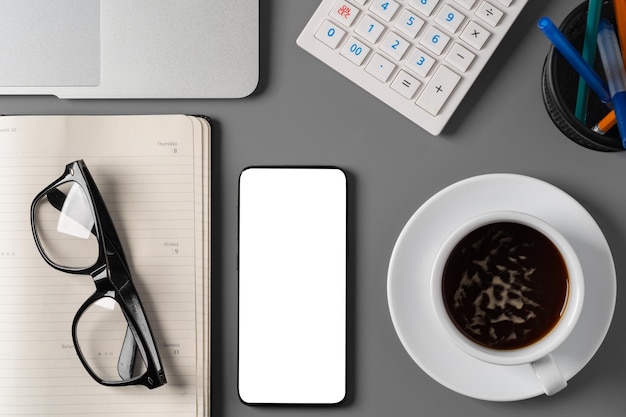 Office desk with notepad glasses and supplies