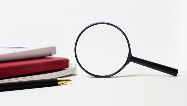 Photo office desk with notepads calculator pen and magnifying glass with space to insert text side view copy space for text