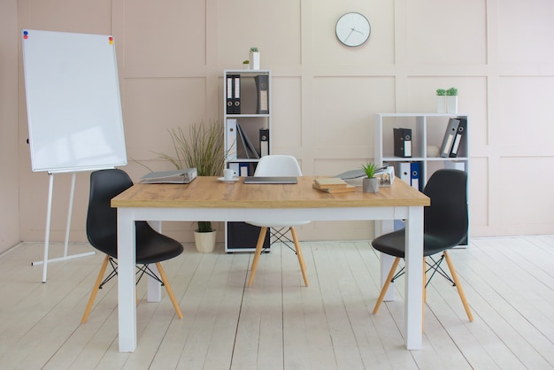 Office desk with portable device and chair next to shelf