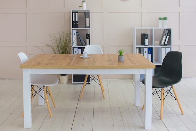 Office desk with portable device and chair next to shelf