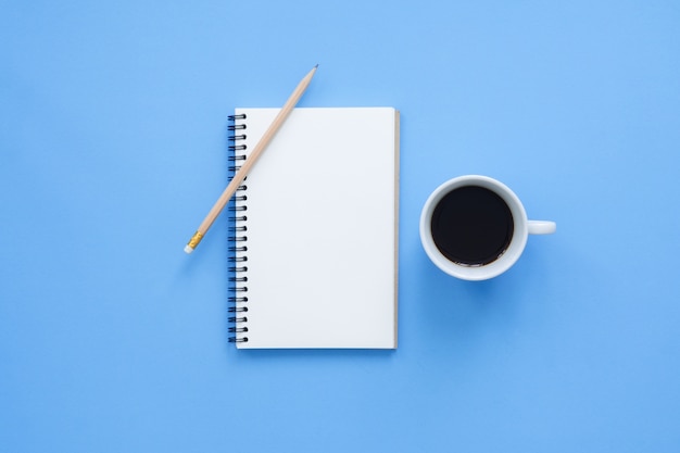 Office desk working space - Flat lay top view mockup of a working space with white blank notebook page