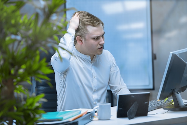 Photo an office employee experiences an attack of depression at his workplace