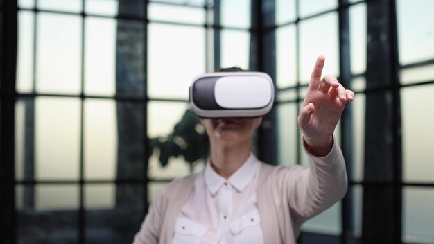 Office employee having fun at work watching 3D video in virtual reality glasses