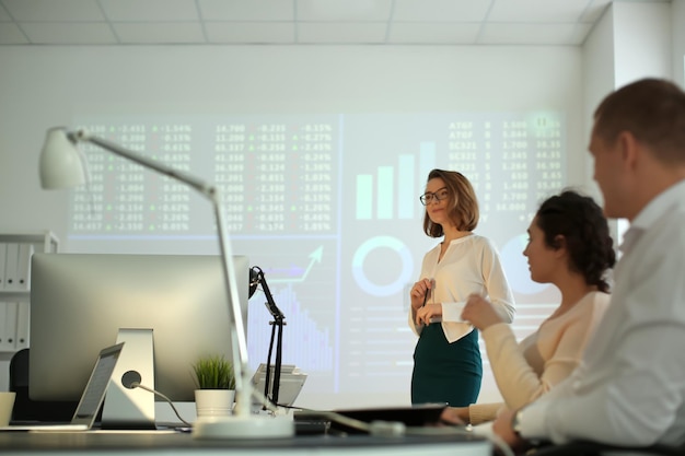 Office employees watching presentation during meeting Forex concept