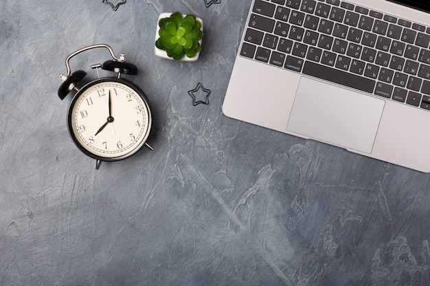 Office Flat lay gray desk with silver laptop computer, coffee mug and stationery