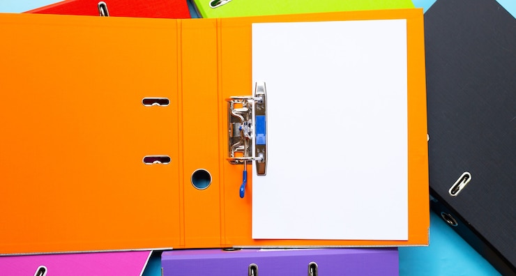 फोटो office folders with paper on blue background. top view