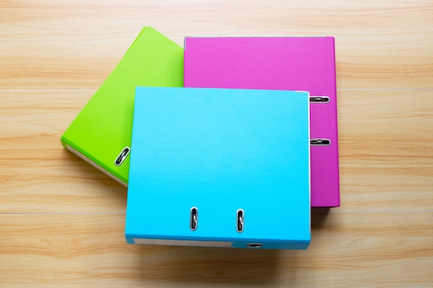 Office folders on wooden table background. Top view