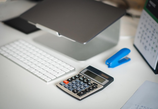 Office gear calculator laptop and keyboard On table