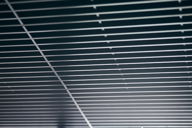 Office grille ceiling. Modern black metal grille ceiling, suspended covering. Abstract design texture.