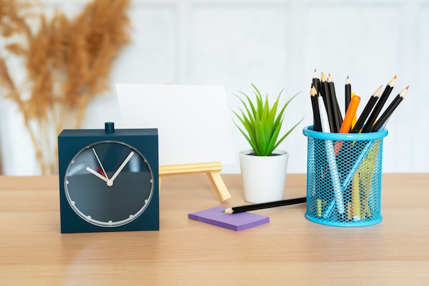 Office interior details with alarm clock and stationery items