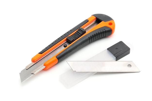 Office knife with replaceable blades on an isolated white backgroundxDxA