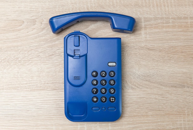 Office landline phone on wooden table