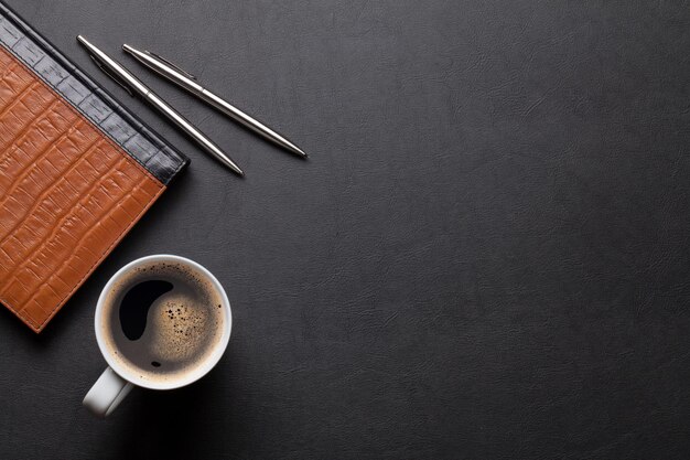 Office leather desk table with notepad and coffee