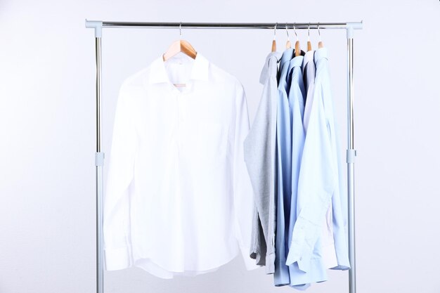 Office male clothes on hangers on gray background