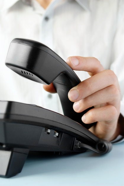 Photo in the office of a man holding up the phone