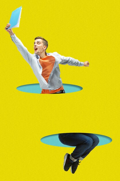 Photo office man jumping high. a person jumping throught blue paper's cutouts on yellow background. dream, paperworld. cutout of paper. contemporary colorful and conceptual art collage with copyspace.