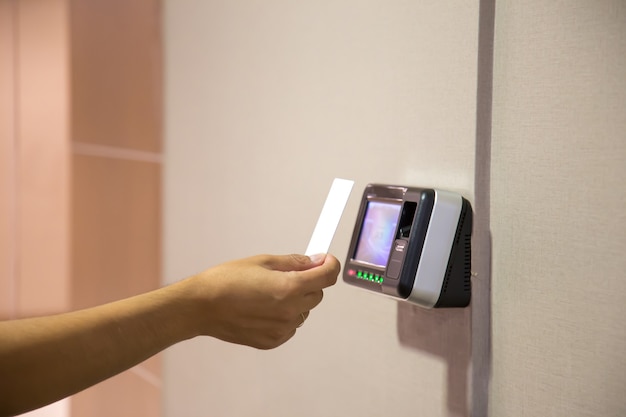 Office man using the id card to scan at the access control.