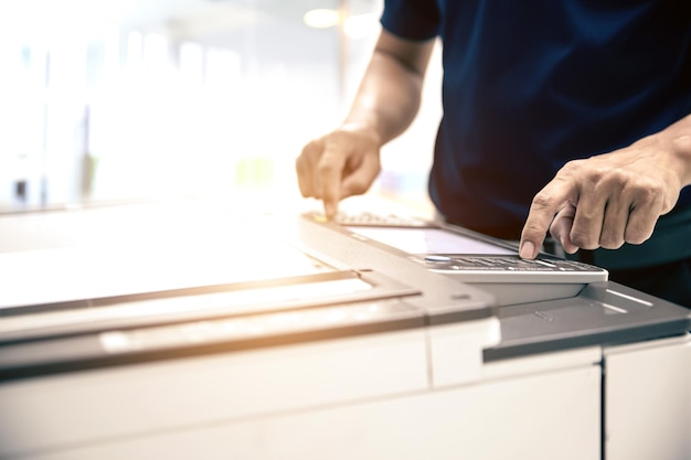 Photo office man using the photocopy in office workplace